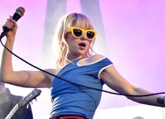 The Paramore lead singer performs with a microphone on stage in a blue shirt, HD Desktop Wallpaper