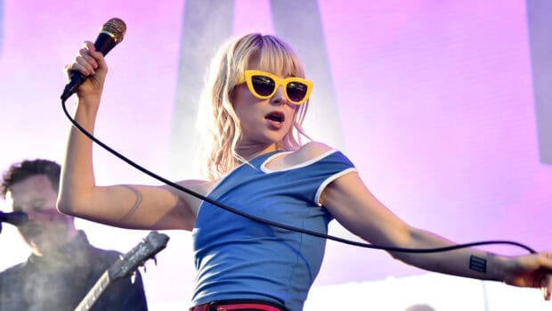 The Paramore lead singer performs with a microphone on stage in a blue shirt, HD Desktop Wallpaper