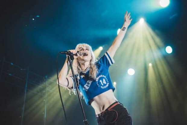 A Paramore singer passionately performs on stage with bright lights, HD Desktop Wallpaper
