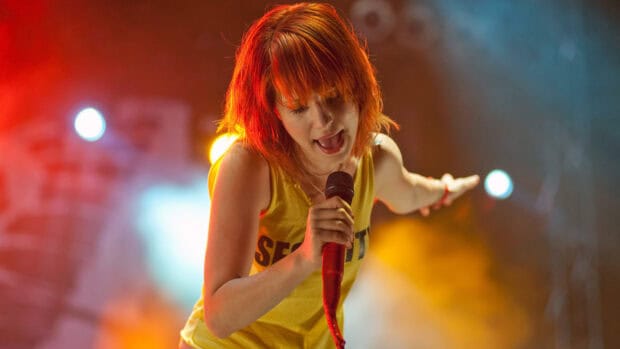 The singer of Paramore is passionately singing on stage with colorful lights, HD Desktop Wallpaper