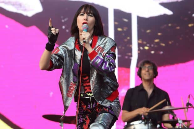 The lead singer of Yeah Yeah Yeahs delivers an energetic live performance with vibrant stage presence, HD Desktop Wallpaper