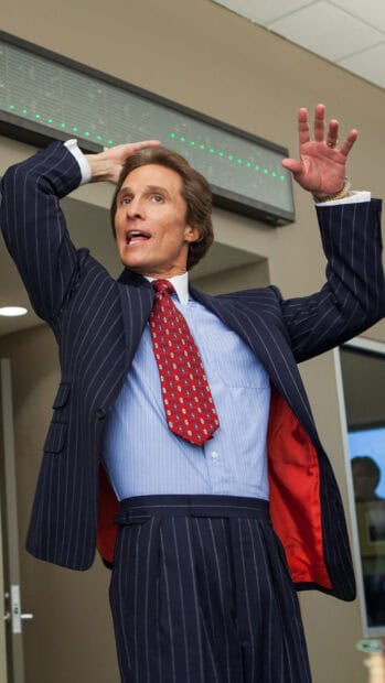 A man in a pinstripe suit raises his hands with confidence in a busy office scene, HD Mobile Wallpaper