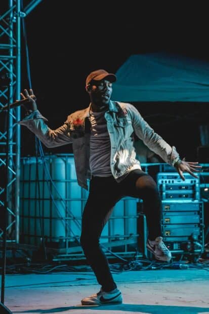 A dynamic stage moment of Anderson Paak dancing during a live show, 2K Mobile Wallpaper