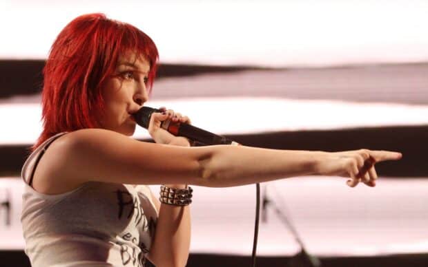 A Paramore singer passionately performs on stage during a live concert, HD Desktop Wallpaper