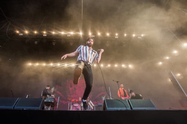 The Foals band is performing live with dynamic stage presence and lighting effects, HD Desktop Wallpaper