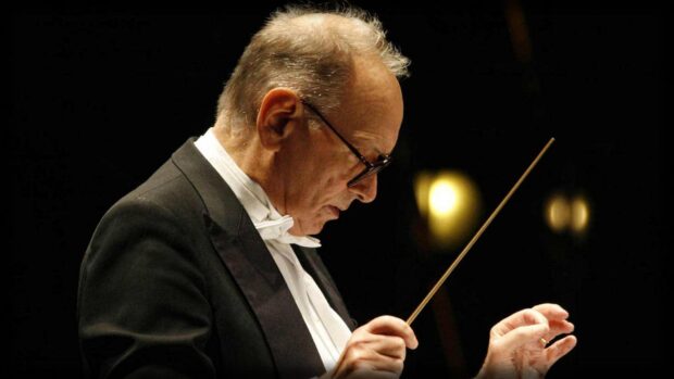 Ennio Morricone is deeply focused while conducting an orchestra, HD Desktop Wallpaper