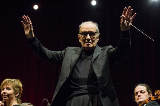Ennio Morricone is conducting a live orchestra performance with focused expression, HD Desktop Wallpaper