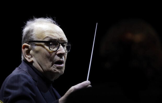Ennio Morricone is conducting an orchestra during a live performance, 2K Desktop Wallpaper