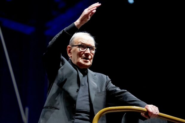 Ennio Morricone is shown conducting an orchestra during a live performance, HD Desktop Wallpaper