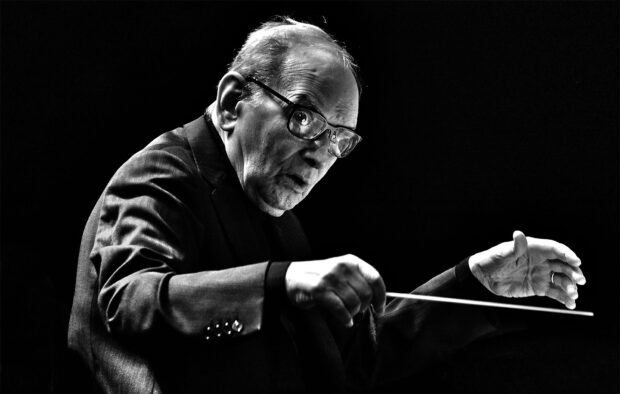 Ennio Morricone is conducting an orchestra passionately in black and white, HD Desktop Wallpaper