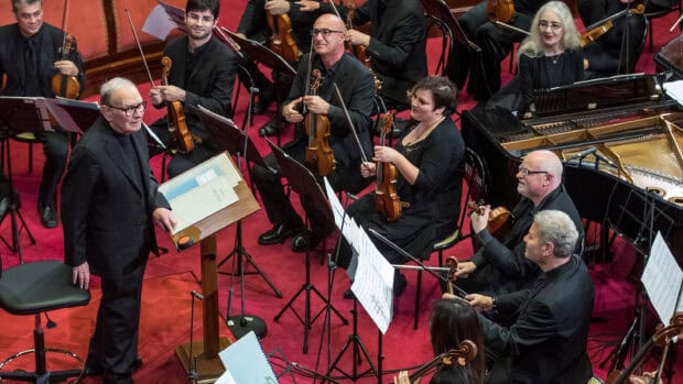 Ennio Morricone leads an orchestra in a classical music performance, 2K Desktop Wallpaper