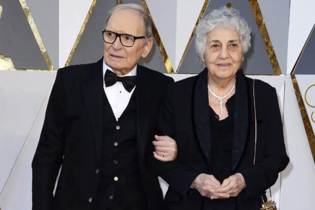 Ennio Morricone is pictured with a woman at a formal event, 2K Desktop Wallpaper