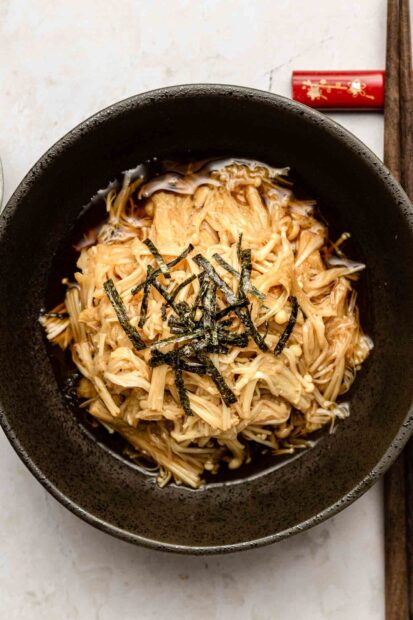 A bowl of enoki mushrooms with seaweed strips in a savory broth, HD Mobile Wallpaper