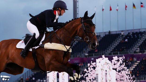 A rider is jumping over an obstacle on a horse during an eventing competition, 2K Desktop Wallpaper