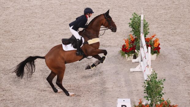 A rider on a horse is preparing to jump over a fence during an eventing competition, 2K Desktop Wallpaper