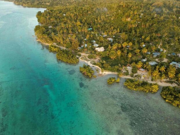 Aerial view of Espiritu Santo Vanuatu showing lush coastline and clear water, HD Desktop Wallpaper