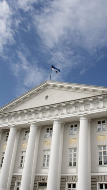 The Estonia flag is waving atop a classical white building with tall columns, HD Phone Wallpaper