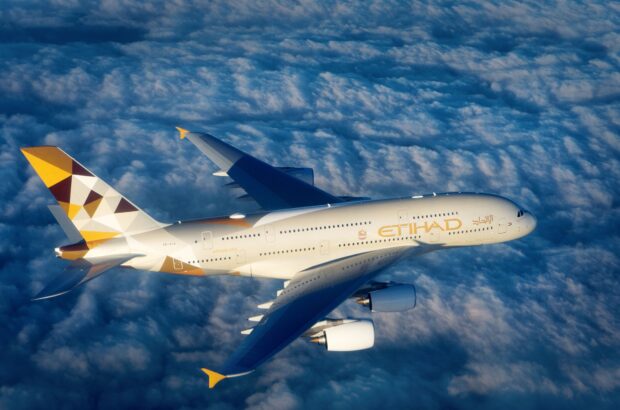 An Etihad Airbus A380 is flying high above the clouds in clear sky, HD Desktop Wallpaper