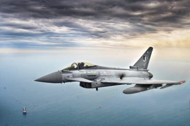 A Eurofighter jet fighter flies above the ocean under a cloudy sky, HD Desktop Wallpaper