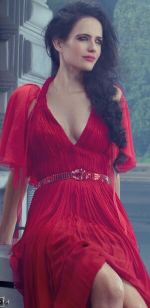 Eva Green Wallpapers features her wearing a stylish red dress while sitting and looking away, 2K Phone Wallpaper
