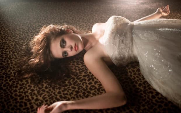 Eva Green poses elegantly on a leopard print fabric wearing a white dress, HD Desktop Wallpaper