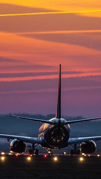 An aircraft prepares for takeoff during a vibrant sunset, HD Phone Wallpaper