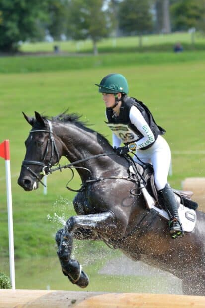 A rider and horse are jumping over a water obstacle in an eventing competition, 2K Mobile Wallpaper