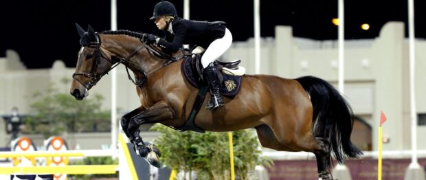 A rider is jumping over an obstacle with a horse during an eventing competition, 2K Desktop Wallpaper