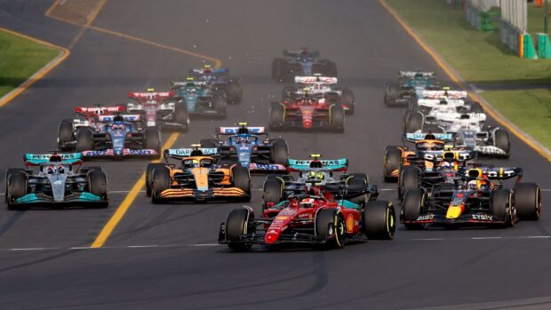 Several F1 race cars compete closely on the track during a high speed race, HD Desktop Wallpaper