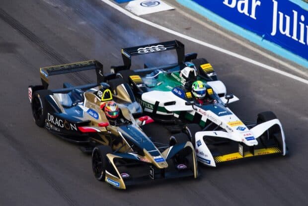 Two F1 race cars closely competing on the circuit during the race, HD Desktop Wallpaper