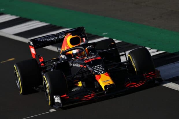 A Red Bull F1 car speeds along the race track during a professional F1 Race, 2K Desktop Wallpaper