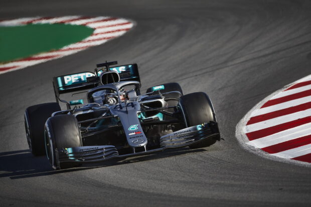 A Formula 1 race car is taking a sharp turn on the racetrack during a high speed competition, HD Desktop Wallpaper