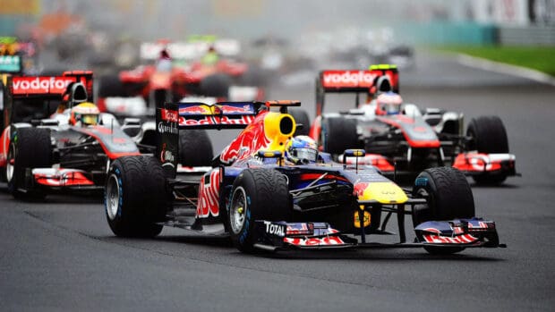 A close up of F1 race cars competing in a high speed competition, HD Desktop Wallpaper