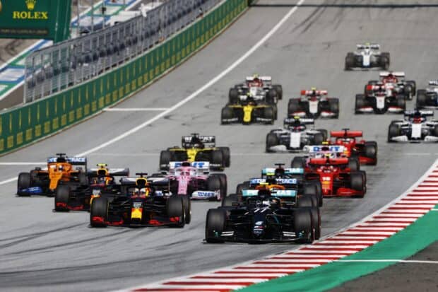 F1 race cars speeding along a professional circuit during a competitive race, 2K Desktop Wallpaper