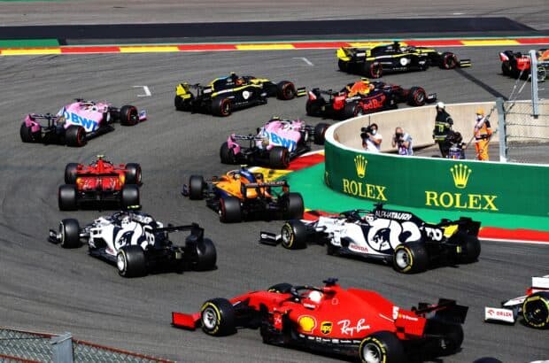 Multiple F1 race cars competing on a circuit during a high speed race, HD Desktop Wallpaper