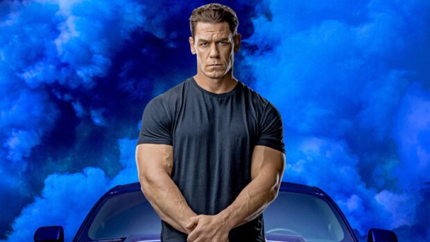 A serious man stands in front of a car with blue smoke behind him in this F9 Wallpapers image, 4K Desktop Wallpaper