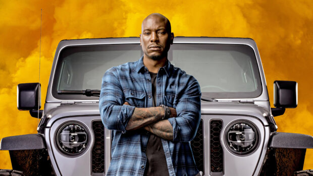 A man stands confidently in front of a jeep with orange smoke behind in F9 Wallpapers, HD Desktop Wallpaper