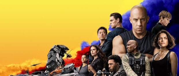 The F9 cast stands against a yellow and blue smoke background in an intense action scene, 2K Desktop Wallpaper