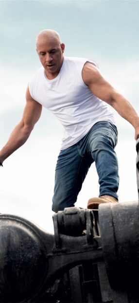 A man is climbing on heavy machinery showing strength in F9 wallpapers, HD Phone Wallpaper