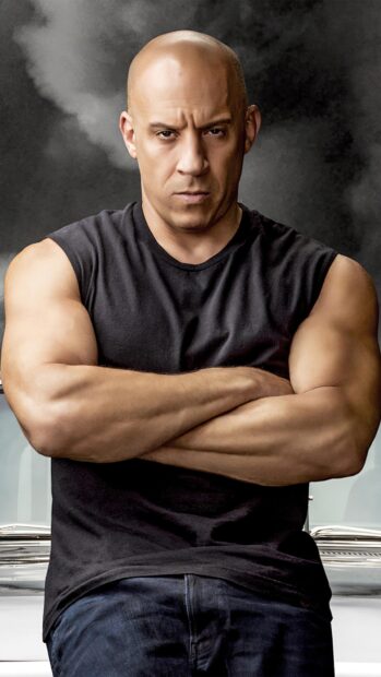 A muscular man with a serious expression stands with crossed arms in F9 Wallpapers, 4K Phone Wallpaper