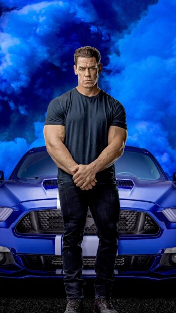 A muscular man stands confidently in front of a blue car with blue smoke in the background featuring F9 wallpapers, HD Phone Wallpaper