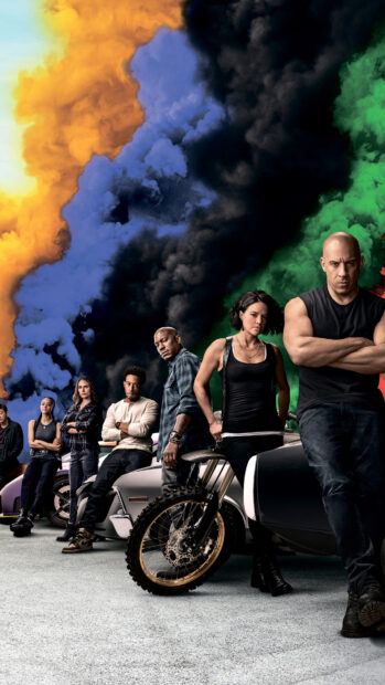 The F9 cast stands with cars and colorful smoke behind them in an action scene, 4K Phone Wallpaper