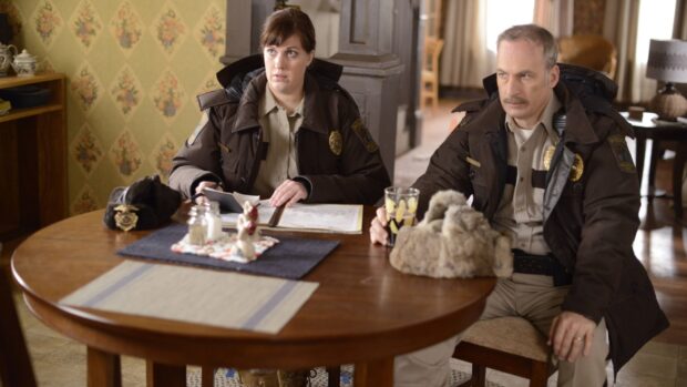 Two police officers are having a serious conversation indoors with documents, HD Desktop Wallpaper