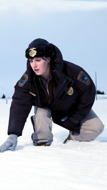 A Fargo police officer wearing winter gear inspects the snow carefully, HD Mobile Wallpaper