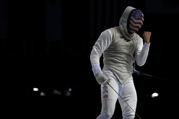 A fencing athlete wearing USA gear celebrates a win during a match, HD Desktop Wallpaper