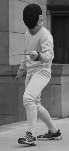 A fencing athlete prepares for a match while wearing traditional gear and holding a sword, HD Mobile Wallpaper