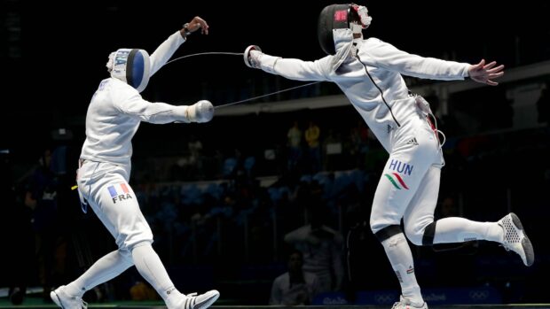 Two fencing athletes compete in a close duel during a match, HD Desktop Wallpaper