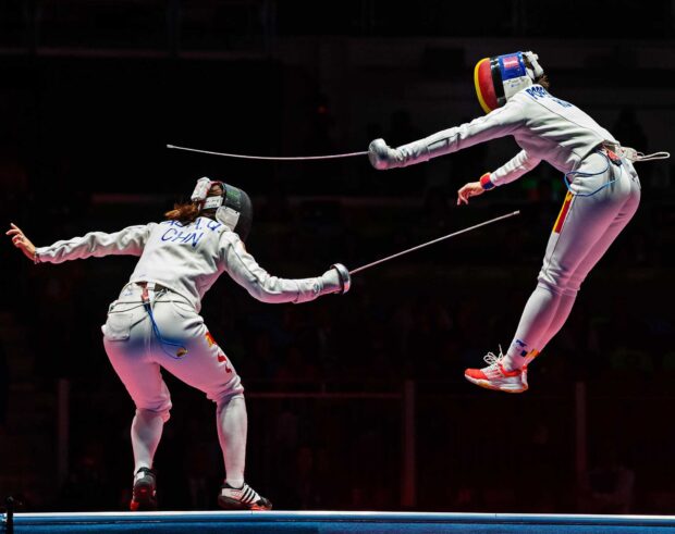 Two fencers compete actively during a fencing match with one airborne, Fencing Wallpapers, HD Desktop Wallpaper