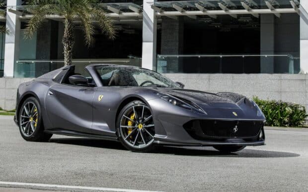 A gray Ferrari 812 Gts is parked near a building with palm trees in the background, HD Desktop Wallpaper
