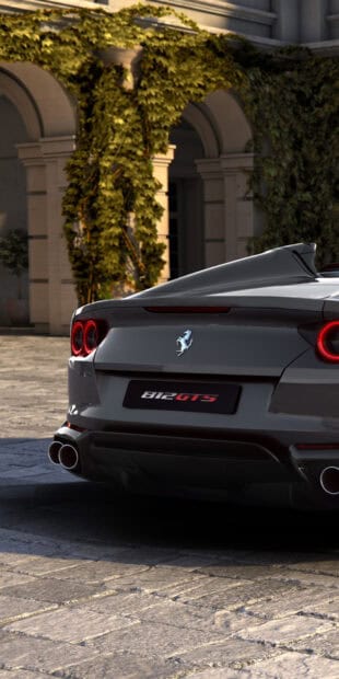 A sleek Ferrari 812 Gts is parked near a building covered with ivy during the day, HD Phone Wallpaper